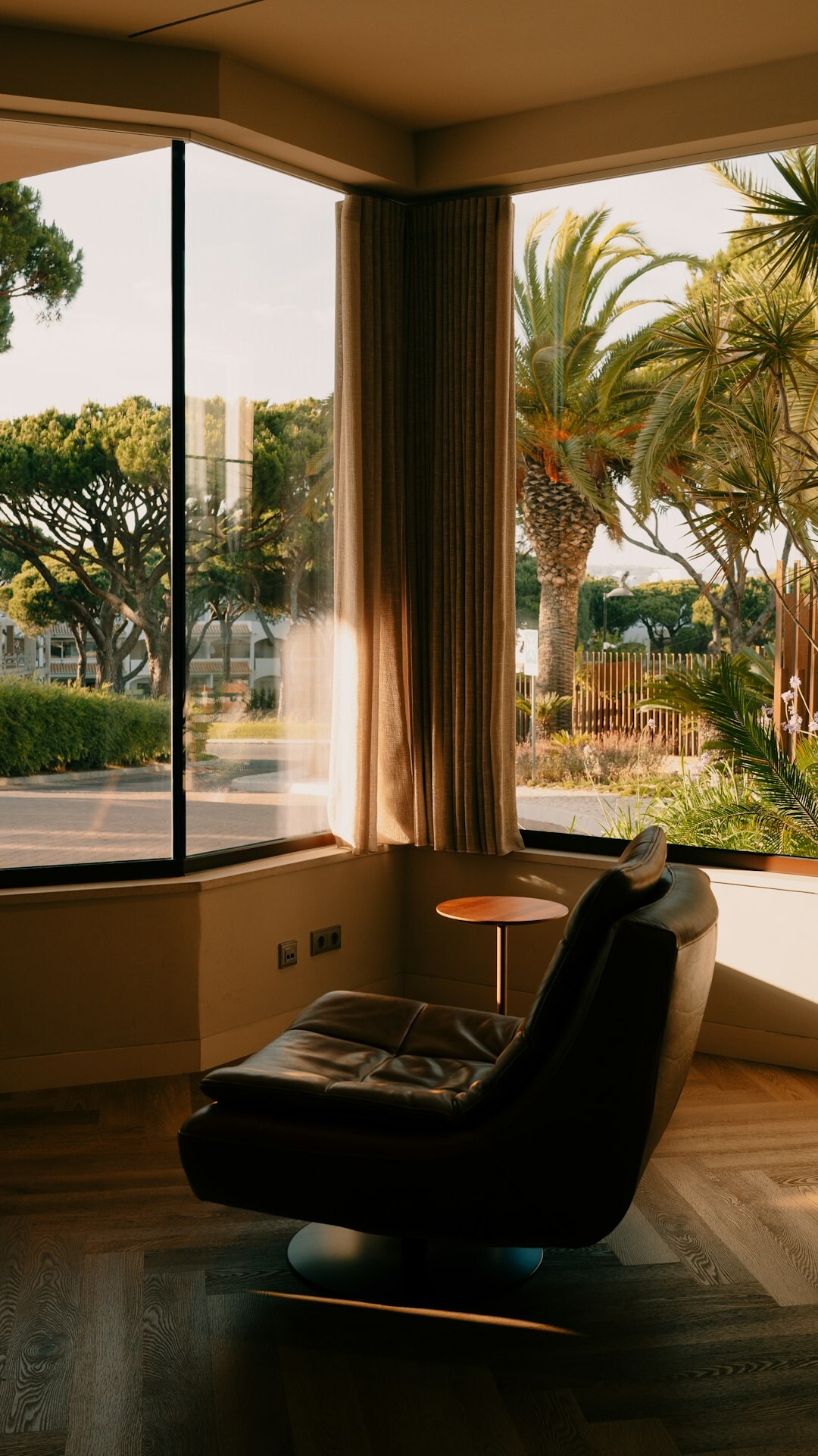 Elegant villa interior with large windows and a mix of modern and vintage furniture